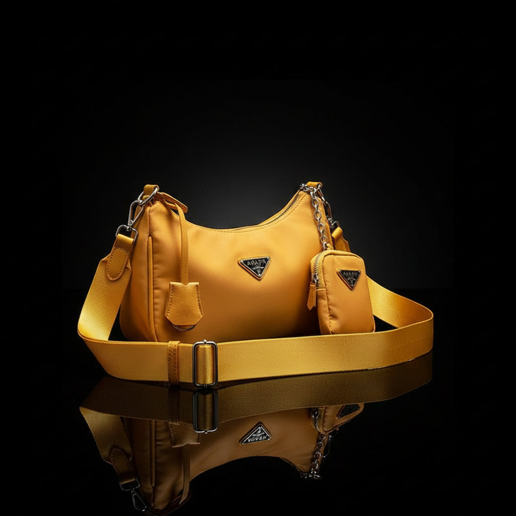 A beige one-shoulder messenger hand bag with a chain strap, displayed on a white surface, possibly a bed or couch.