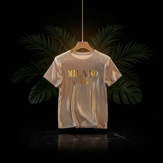 A sparkling champagne golden graphic t-shirt with 'MILANO Italy' printed on the front, displayed on a beige background.