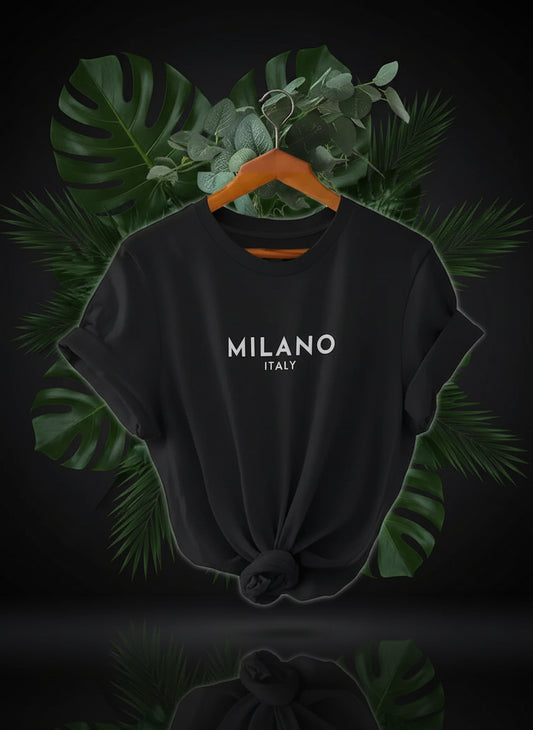 A white crew neck t-shirt with 'MILANO Italy' printed on the front, displayed on a hanger.