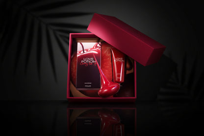 Red 'Love Potion' perfume bottle and packaging in a box on a light blue background