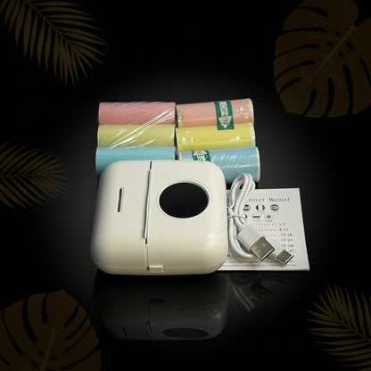 A portable mini thermal printer in pink color, showing the front, side, and back views with dimensions.