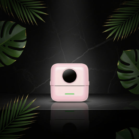 A portable mini thermal printer in pink color, showing the front, side, and back views with dimensions.