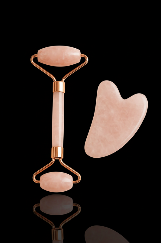 Rose quartz roller and gua sha tool on a beige background