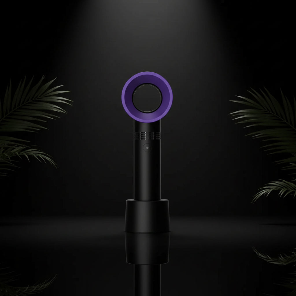 A handheld rechargeable eyelash blower with a pink circular mouthpiece and a teal blue body, being held in a person's hand.