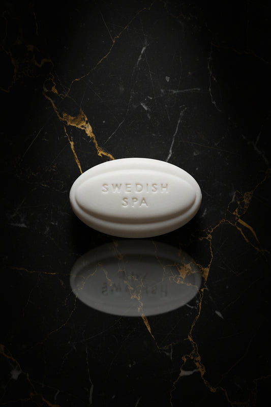 Bar of soap labeled 'Swedish Spa' on a textured surface