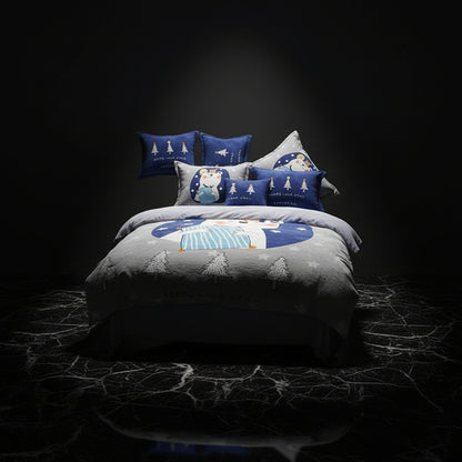 A four-piece bed sheet set with a cartoon theme, featuring a blue color with white polka dots and text, displayed on a bed with pillows and a quilt.