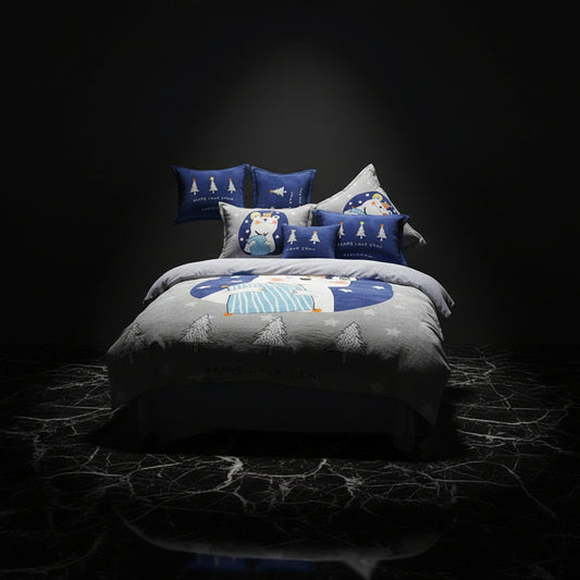 A four-piece bed sheet set with a cartoon theme, featuring a blue color with white polka dots and text, displayed on a bed with pillows and a quilt.