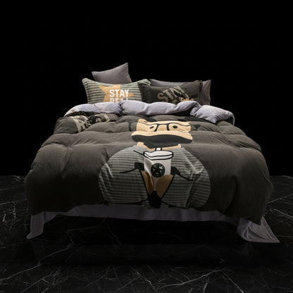 A four-piece bed sheet set with a cartoon theme, featuring a blue color with white polka dots and text, displayed on a bed with pillows and a quilt.